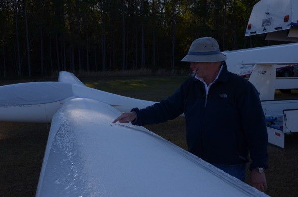 Jim Garrison (T) writing a message in the frost on one wing of his duo